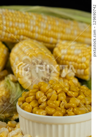 Canned Sweet Corn In Bowl Surrounded By Fresh Corn Cobs. Canned Sweet Corn In Bowl Surrounded By Fresh Corn Cobs. 129690742