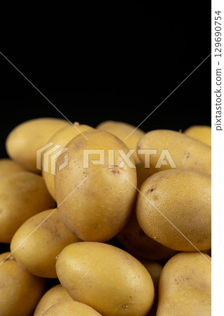 Fresh raw unpeeled potatoes close-up 129690754