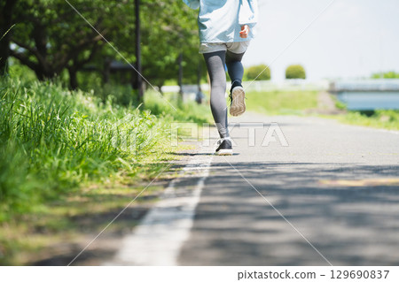 Young woman running sports image 129690837