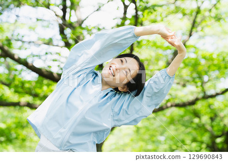 Young woman stretching, sports image Young woman stretching, sports image 129690843