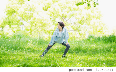 Young woman stretching, sports image Young woman stretching, sports image 129690844