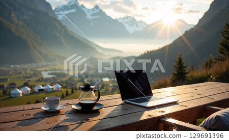 Laptop on wooden table mountains 129691396