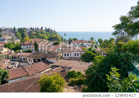 View of a town with houses and a beach View of a town with houses and a beach 129691417