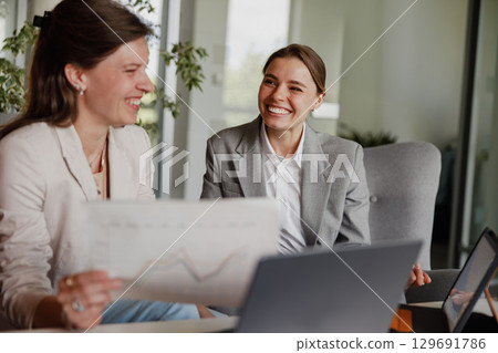 Business Partners Engaged in Productive Collaboration within a Modern Office Environment 129691786