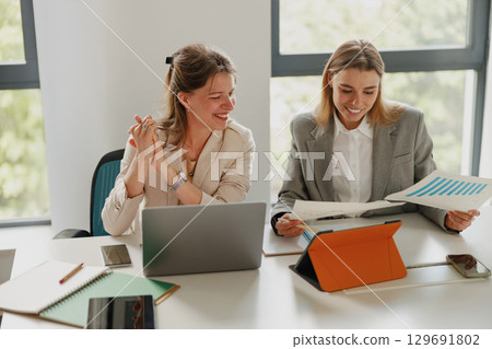 Professional Women Collaborating Effectively in a Modern Office Setting for Growth and Success 129691802