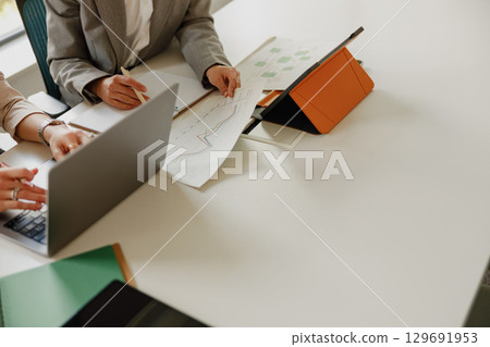 Engaging in a Collaborative Business Meeting with Laptops, Documents, and Innovative Ideas Engaging in a Collaborative Business Meeting with Laptops, Documents, and Innovative Ideas 129691953