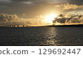The sunset that colors the sky and sea of Miyakojima The silhouette of Irabu Bridge 129692447