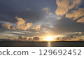 The sunset that colors the sky and sea of Miyakojima The silhouette of Irabu Bridge 129692452