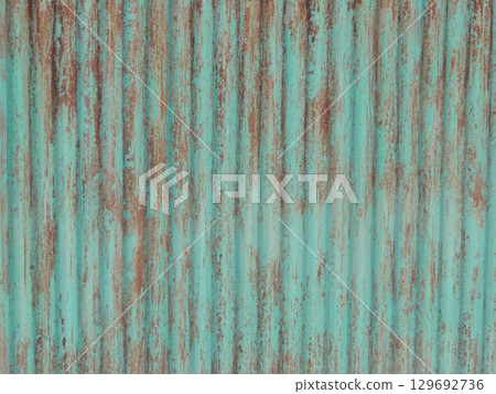 corrugated iron material fence corroded under peeling green paint, rustic old fence texture of oxidized metal with peeling paint corrugated iron material fence corroded under peeling green paint, rustic old fence texture of oxidized metal with peeling paint 129692736