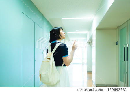 A woman walking inside the facility A woman walking inside the facility 129692881
