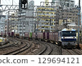 A long freight train on the quadruple-track Tokaido Main Line passes Motomachi Station in Kobe 129694121