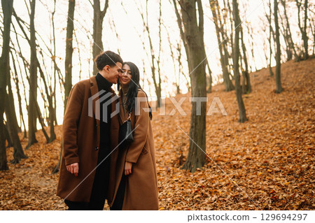 Young couple in love walking in the park on a autumn day. Enjoying time together. 129694297
