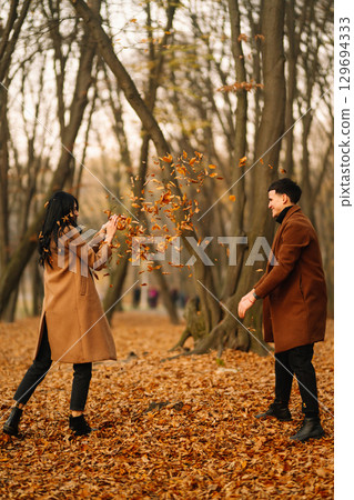 Young couple in love walking in the park on a autumn day. Enjoying time together. 129694333