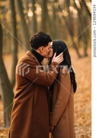 Young couple in love walking in the park on a autumn day. Enjoying time together. 129694334