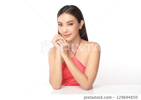 A beautiful young Asian woman with clean, fresh skin against a white background. Skincare, facial treatment, cosmetology, beauty, and spa. An elegant portrait of an Asian woman. A beautiful young Asian woman with clean, fresh skin against a white background. Skincare, facial treatment, cosmetology, beauty, and spa. An elegant portrait of an Asian woman. 129694850