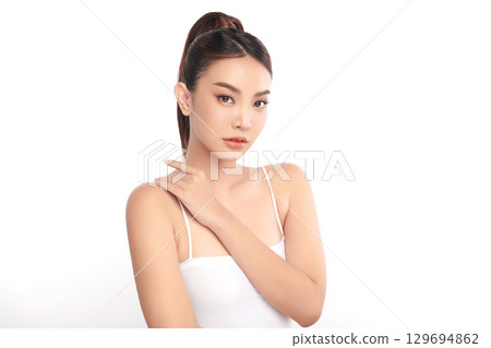 A beautiful young Asian woman with clean, fresh skin against a white background. Skincare, facial treatment, cosmetology, beauty, and spa. An elegant portrait of an Asian woman. A beautiful young Asian woman with clean, fresh skin against a white background. Skincare, facial treatment, cosmetology, beauty, and spa. An elegant portrait of an Asian woman. 129694862