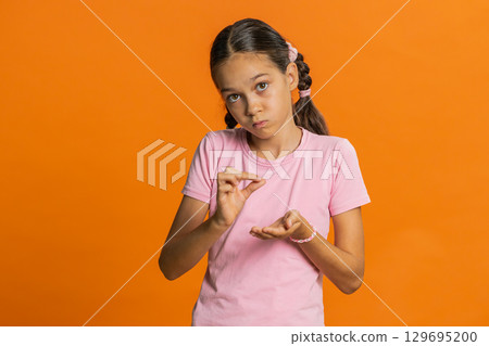 Child girl show a little bit gesture begging help need some more please give me measuring small size Child girl show a little bit gesture begging help need some more please give me measuring small size 129695200