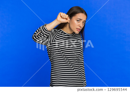 Confused Caucasian woman knocking door gesture asking who is at home feeling embarrassed no idea 129695544
