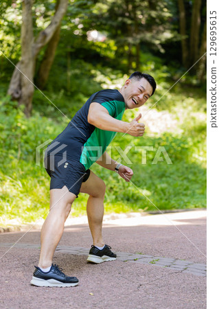 Athletic fitness sport motivated runner man training marathon run starting race showing thumb up 129695615