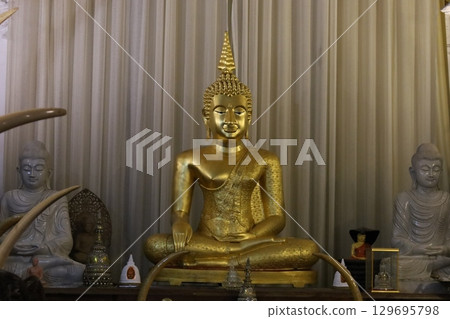 Buddha statue at the Temple of the Tooth [Kandy, Sri Lanka] 129695798