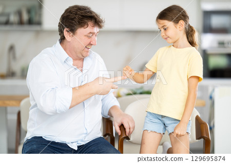 Father and daughter playing rock paper scissors Father and daughter playing rock paper scissors 129695874