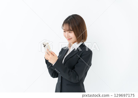 Young woman business smartphone Young woman business smartphone 129697175