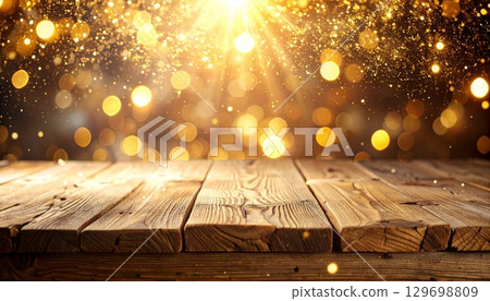 Golden Shimmering Bokeh Over Dark Brown Wooden Tabletop For Festive Decor 129698809