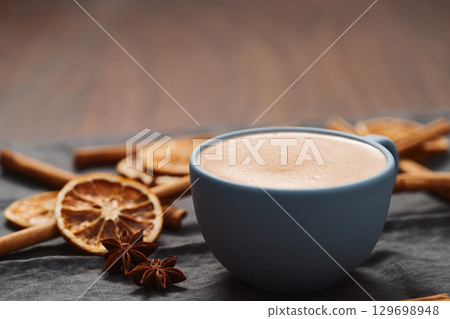 Hot chocolate in a blue cup with natural christmas decorations 129698948