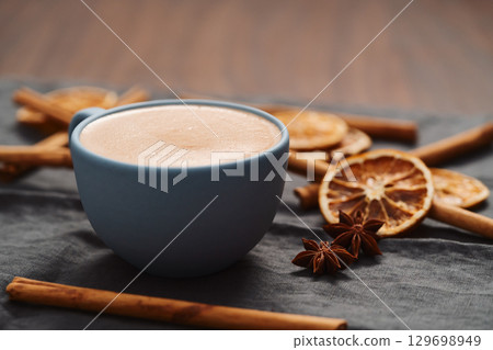Hot chocolate in a blue cup with natural christmas decorations 129698949
