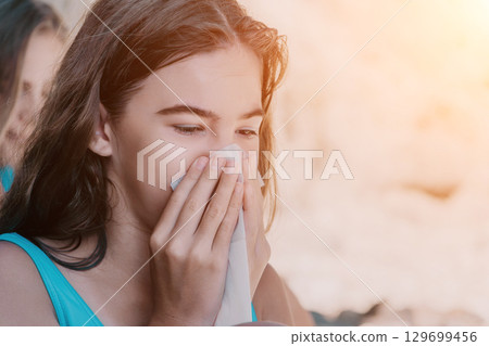 Young Girl Blowing Her Nose Young Girl Blowing Her Nose 129699456