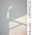 A minimalist landscape of light and shadows from a window reflected on a white wall 129700126