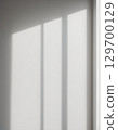 A minimalist landscape of light and shadows from a window reflected on a white wall 129700129