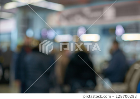 Blurry crowd in busy indoor setting with diverse adults 129700288
