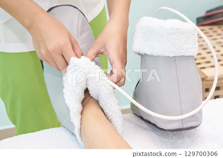 Foot therapy session with heated boot for relaxation and comfort Foot therapy session with heated boot for relaxation and comfort 129700306