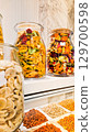 A variety of nuts and dried fruits displayed on a market stall.  Eco food, vegetarian diet, organic snacks, and healthy natural nutrition. 129700598