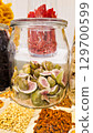 A variety of nuts and dried fruits displayed on a market stall.  Eco food, vegetarian diet, organic snacks, and healthy natural nutrition. 129700599