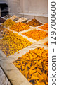 A variety of nuts and dried fruits displayed on a market stall.  Eco food, vegetarian diet, organic snacks, and healthy natural nutrition. 129700600