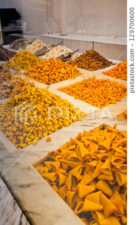 A variety of nuts and dried fruits displayed on a market stall.  Eco food, vegetarian diet, organic snacks, and healthy natural nutrition. 129700600