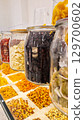 A variety of nuts and dried fruits displayed on a market stall.  Eco food, vegetarian diet, organic snacks, and healthy natural nutrition. 129700602