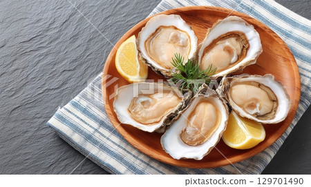 Fresh Oyster Platter on Wooden Plate with Lemon Slices and Herbs for Gourmet Cuisine Presentation Fresh Oyster Platter on Wooden Plate with Lemon Slices and Herbs for Gourmet Cuisine Presentation 129701490