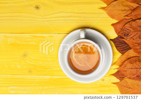 Tea cup with dry leaves making autumn composition Tea cup with dry leaves making autumn composition 129701537