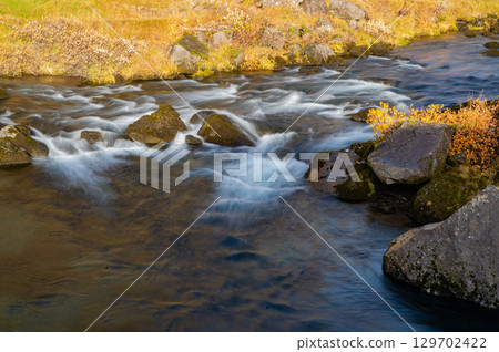 waterfall river rapid in cascade. river stream nature. natural stream of river. water of river flow outdoor in wilderness. brook nature. waterfall creek in autumn 129702422