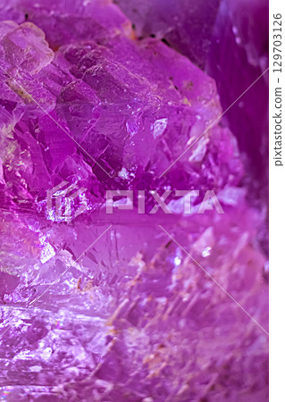 Striking mineral texture of amethyst, consisting of pink crystals. Natural geological formation for background or backdrop 129703126