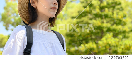 A woman takes a stroll in the summer A woman takes a stroll in the summer 129703705