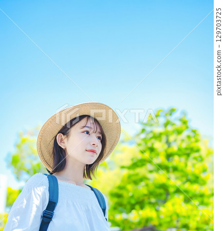 A woman takes a stroll in the summer 129703725