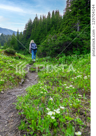 Female Hiker on Mountain Trail in Spring 129704144