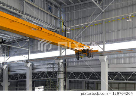 Overhead crane or lifting equipment inside factory or warehouse. Overhead crane or lifting equipment inside factory or warehouse. 129704204