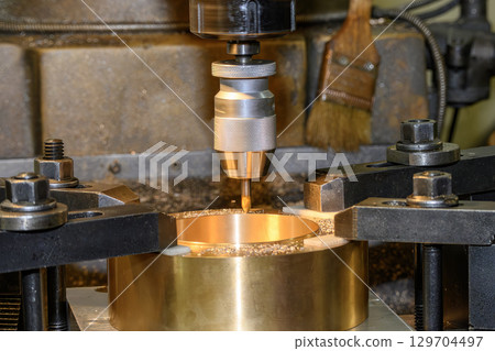 The hole drilling process the brass material parts on NC milling machine by center drill tools. 129704497