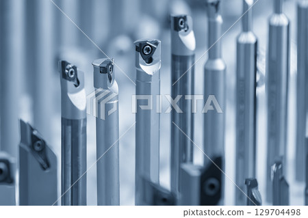 The group of CNC lathe tool in the blue tone scene scene. 129704498