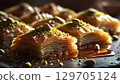 Delicious baklava with intricate layers and pistachio topping, sweet delight 129705124